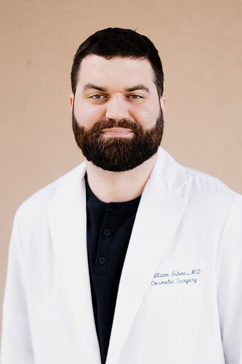 Portrait of Lafayette cosmetic surgeon, Dr. William Ishee, smiling while wearing a white surgical coat